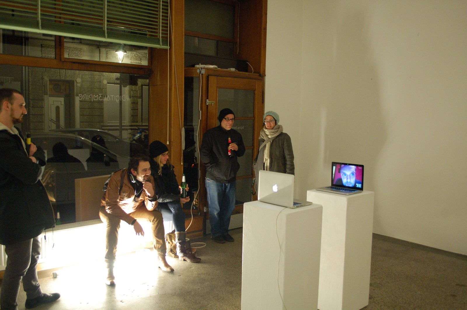 Aethertalk I — two laptops on pedestals, the audience in front of the gallery window