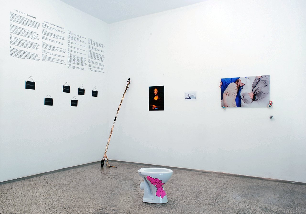 The Internet Is Present Part 2 — installation view with theses wall, Mona Lisa print and painted toilet